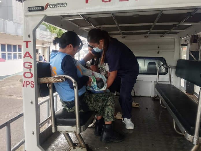 Policewomen of the Tago Municipal Police Station assist a pregnant woman as she gives birth inside a patrol car while being rushed the Adela Ty Memorial Hospital in Tandag Ciy. Both mother and newborn were reported safe. PHOTO COURTESY OF TAGO MUNICIPAL POLICE STATION