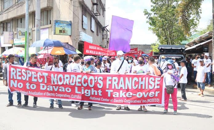 Member-consumers of the Northern Davao Electric Cooperative (Nordeco) march around the streets of Tagum City in this photo on March 23, 2023, to protest the proposed expansion of Davao Light and Power Company in the franchise area of the electric cooperative. CHRIS V. PANGANIBAN