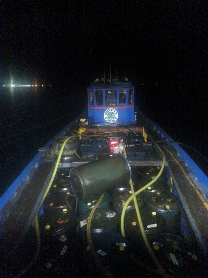 The motorized banca, known locally as a "bote-bote," that carries the illegal fuel products into a tanker truck at the port. Photo courtesy of CIDG Surigao del Norte From the “bote bote”, a duel tanker siphons the illegal diesel fuels supposedly for distribution to local gas stations. Photo courtesy of CIDG Surigao del Norte