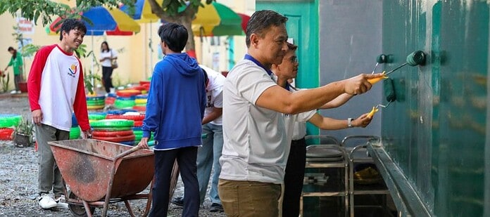 Education Secretary Sonny Angara helps paint the wall of the school building of Cabadbaran National High School as he led the national launch of Brigada Eskwela in Cabadbaran City. Photo courtesy of DepEd website