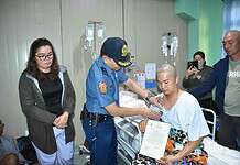 Wounded Caraga cop receives bravery medal, financial aid