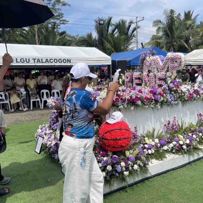 Rovelyn Baterbonia, mother of basketball stand out Rene Clert Baterbonia, sprinkles holy water to his tomb after the 4th day commemoration mass. CHRIS V. PANGANIBAN