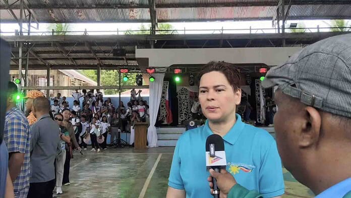 Vice President Sara Duterte speaks to John Sahay, reporter of DXGP 89.7 FM, in an interview during her visit to grace the patronal feast of Barangay Bigaan in Hinatuan, Surigao del Sur. Screenshot photo in the video of John Sahay