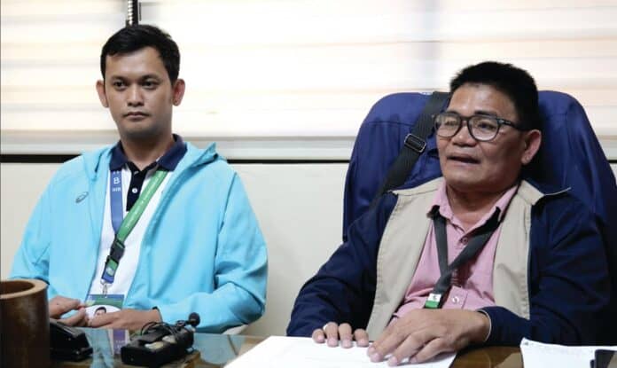 DENR-EMB Caraga Regional Director Ramon Abogadie (right) and Engineer Albert Kenneth Arcamo discuss the continuing haze situation in the region and the public health measures needed to reduce exposure to harmful air pollutants.PIA Caraga photo