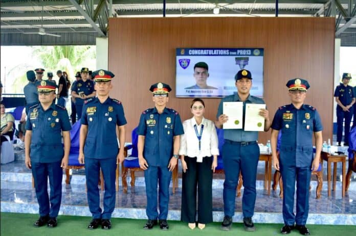 Patrolman Justeen Reo G. Ga holds his citations after receiving the Medalya ng Sugatang Magiting during a heroes’ welcome ceremony for 887 Caraga police personnel deployed for the first BARMM Parliamentary Elections on September 18 at Camp Col. Rafael C. Rodriguez in Butuan City. Ga was injured in the line of duty during a shooting incident at Central Pilot Elementary School in Cotabato City on September 14. PHOTO COURTESY OF PRO 13