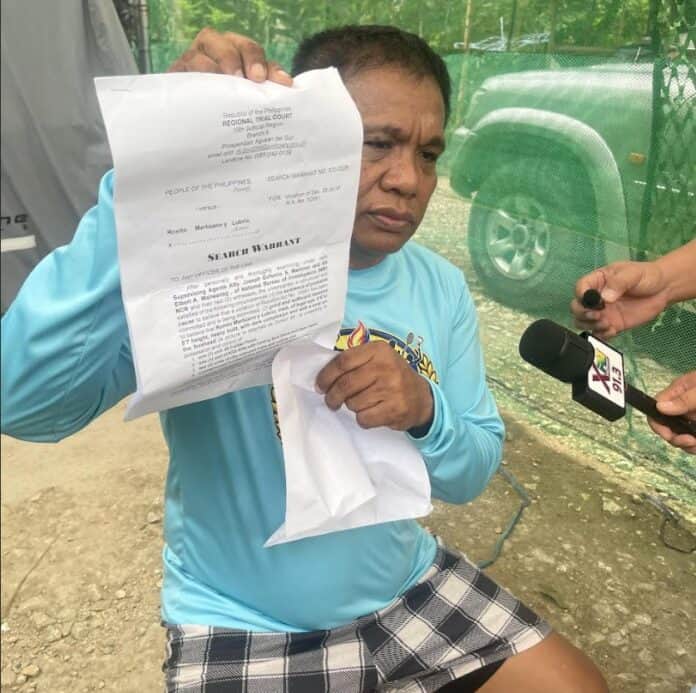 Barobo, Surigao del Sur Mayor Ronito Martizano shows a copy of the search warrant issued against him after NBI agents conducted a search at his residence in Barangay Hubang, San Francisco, Agusan del Sur, on Wednesday, Sept. 23. Martizano said no firearms listed in the warrant were found during the operation and questioned the circumstances surrounding the raid.CHRIS V. PANGANIBAN